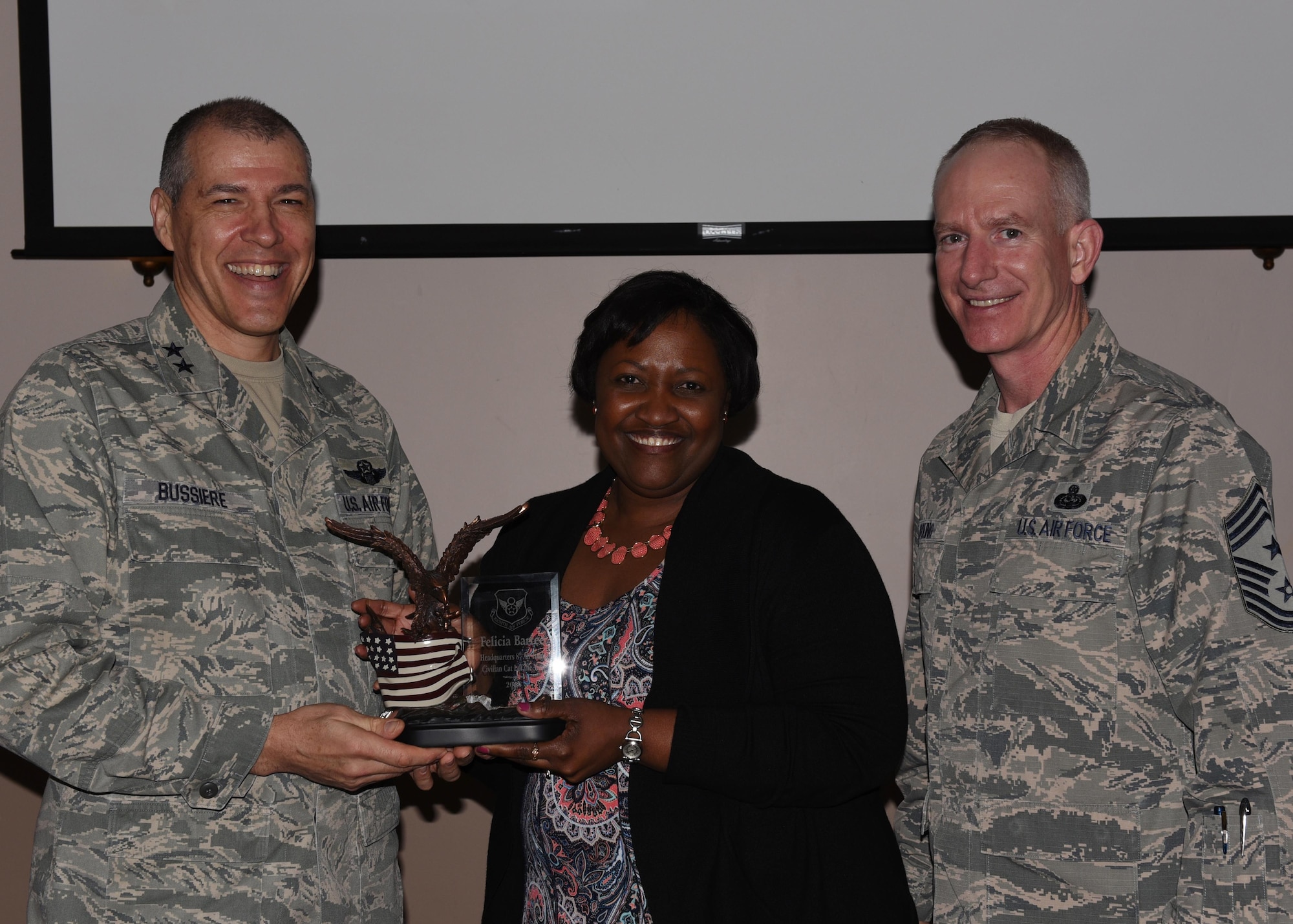 Felicia Bartee, Headquarters Eighth Air Force command section, is named Category One Civilian of the Year during the 2016 Headquarters Eighth Air Force Annual Awards ceremony at Barksdale Air Force Base, La., Feb. 27, 2017. Maj. Gen. Thomas Bussiere, Eighth Air Force commander, and Chief Master Sgt. Alan Boling, Eighth Air Force command chief, presented awards to Airmen and civilians assigned to Headquarters Eighth Air Force to recognize their professionalism and successes throughout the year. (U.S. Air Force photo by Senior Airman Erin Trower)