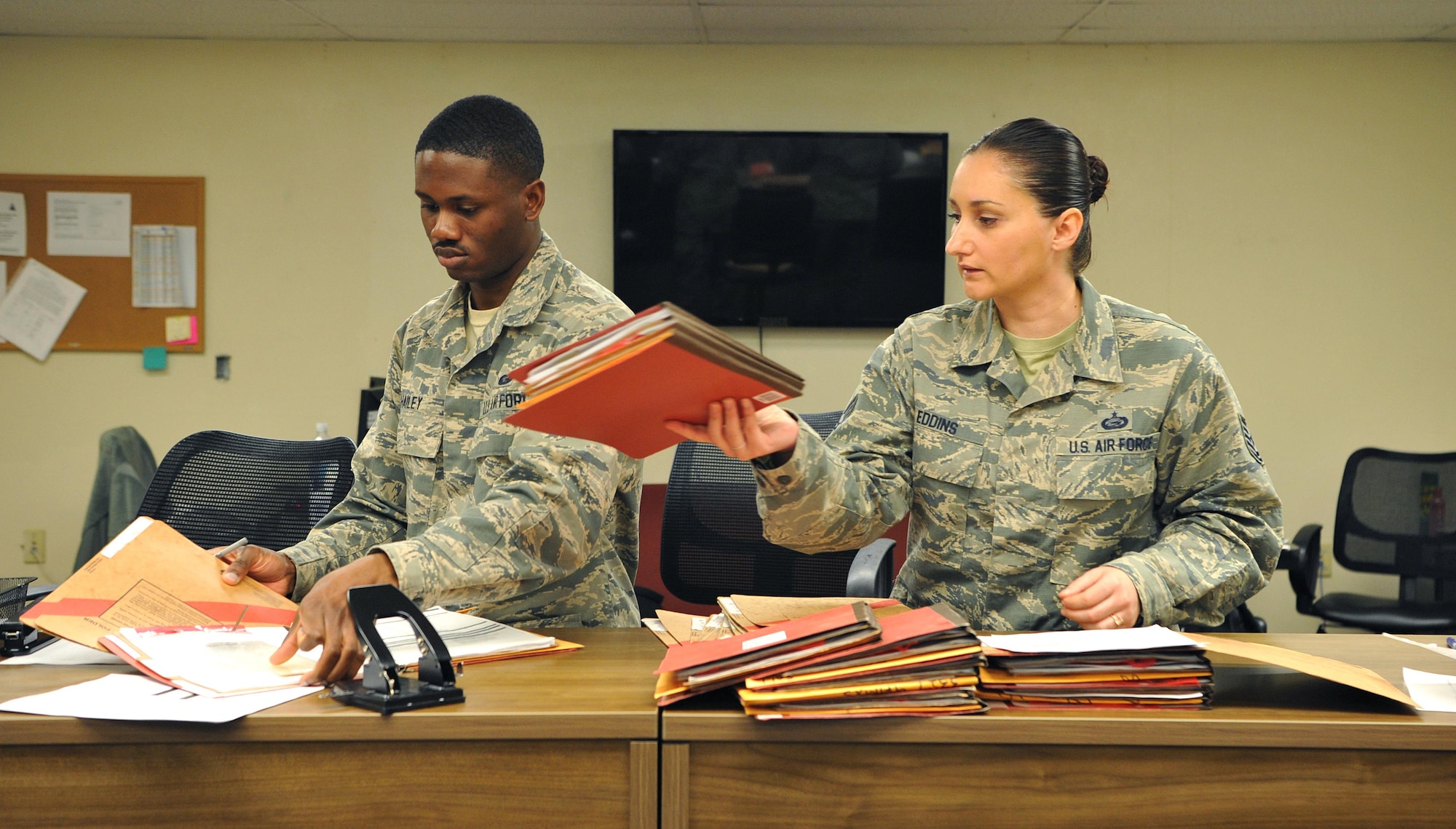 Tech. Sgt. Cassandra Eddins, 9th Force Support Squadron noncommissioned officer in charge of installation personnel readiness, and Senior Airman Kelvin Hailey, 9th FSS IPR journeyman, complete out-processing paperwork for deployers at Beale Air Force Base, California, Feb. 22, 2017. IPR reviews paperwork to ensure there are no discrepancies before individuals leave their home station. (U.S. Air Force photo/Airman Tristan D. Viglianco)
