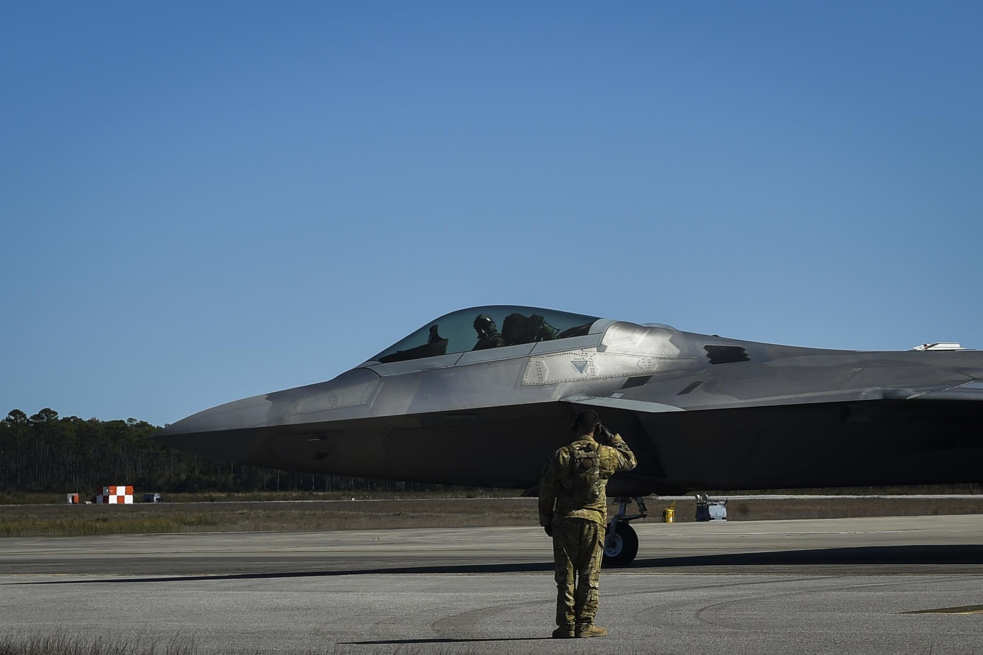 An F-22 Raptor assigned to the 95th Fighter Squadron, Tyndall Air Force Base, Fla., departs after receiving fuel from an MC-130J Commando II tanker aircraft assigned to the 9th Special Operations Squadron, Cannon AFB, N.M, during a forward area refueling point operation at Hurlburt Field, Fla., Feb. 26, 2017. FARP Airmen with the 1st Special Operations Logistic Readiness Squadron refueled three F-22s from an MC-130J during the operation. (U.S. Air Force photo by Airman 1st Class Joseph Pick)