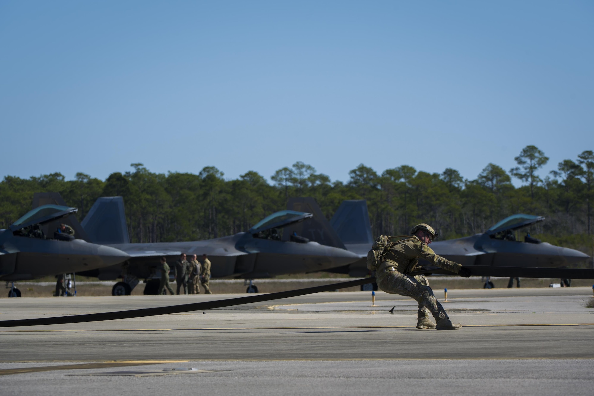 A forward area refueling point Airmen with the 1st Special Operations Logistic Readiness Squadron pulls a fuel hose during a FARP operation at Hurlburt Field, Fla., Feb. 26, 2017. The FARP program is a United States Special Operations Command initiative that trains petroleum, oils and lubrication Airmen to perform covert, nighttime refueling operations in deployed locations where fueling stations are not accessible or when air-to-air refueling is not possible. (U.S. Air Force photo by Airman 1st Class Joseph Pick)