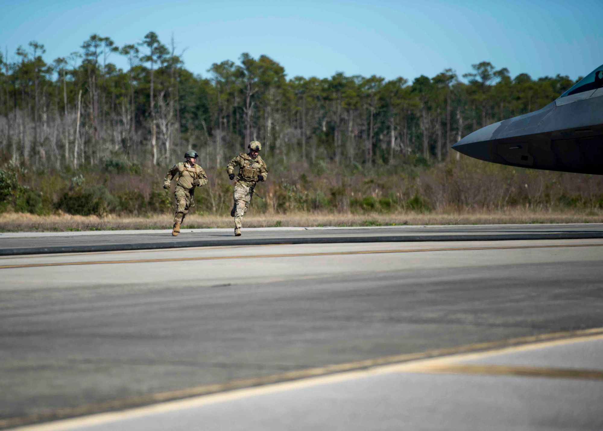 Forward area refueling point Airmen with the 1st Special Operations Logistic Readiness Squadron sprint around an F-22 Raptor during a FARP operation at Hurlburt Field, Fla., Feb. 26, 2017. FARP Airmen refueled three F-22s from an MC-130J Commando II tanker aircraft assigned to the 9th Special Operations Squadron, Cannon AFB, N.M. (U.S. Air Force photo by Senior Airman Krystal Garrett)