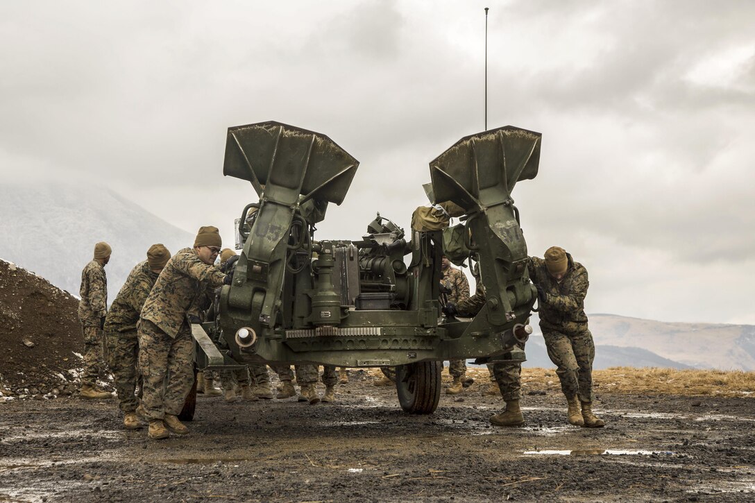 Marines push an M777A2 Howitzer into a different location in the Hijudai Maneuver Area, Japan, Feb. 24, 2017. Marines and sailors participated in the artillery relocation training program in part to enhance combat operational readiness and international relationships. The Marines are assigned to the 12th Marine Regiment. Marine Corps photo by Lance Cpl. Christian J. Robertson

