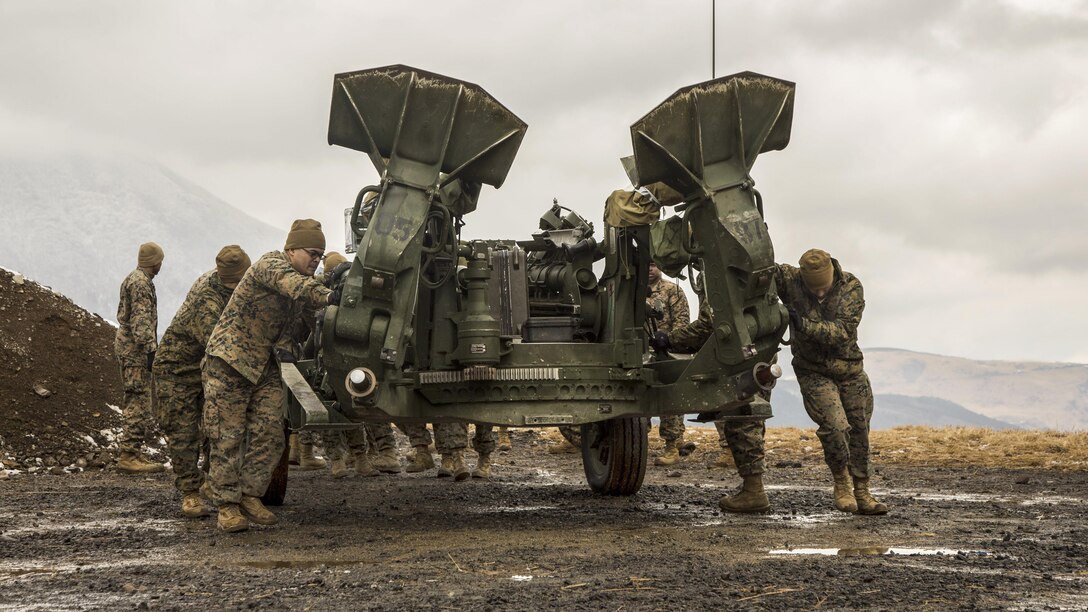 Marines push an M777A2 Howitzer into a different location in the Hijudai Maneuver Area, Japan, Feb. 24, 2017. Marines and sailors participated in the artillery relocation training program in part to enhance combat operational readiness and international relationships. The Marines are assigned to the 12th Marine Regiment. Marine Corps photo by Lance Cpl. Christian J. Robertson
