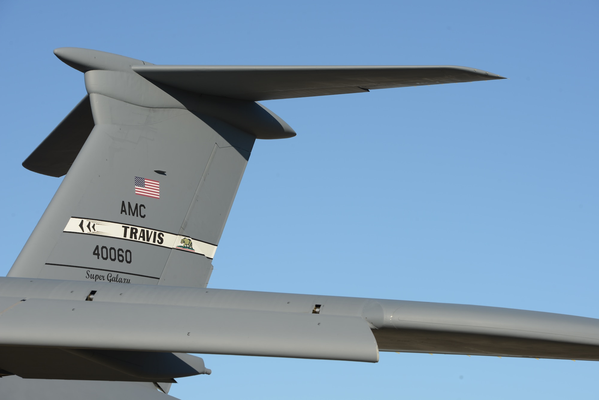 The tail of an Air Force C-5 Super Galaxy at Travis Air Force Base, Calif. Travis aircraft, like the C-5 seen here, support the USS Ronald Reagan, delivering parts and supplies by air when requested. (U.S. Navy photo/Chief Mass Communication Specialist Xander Gamble/Released)