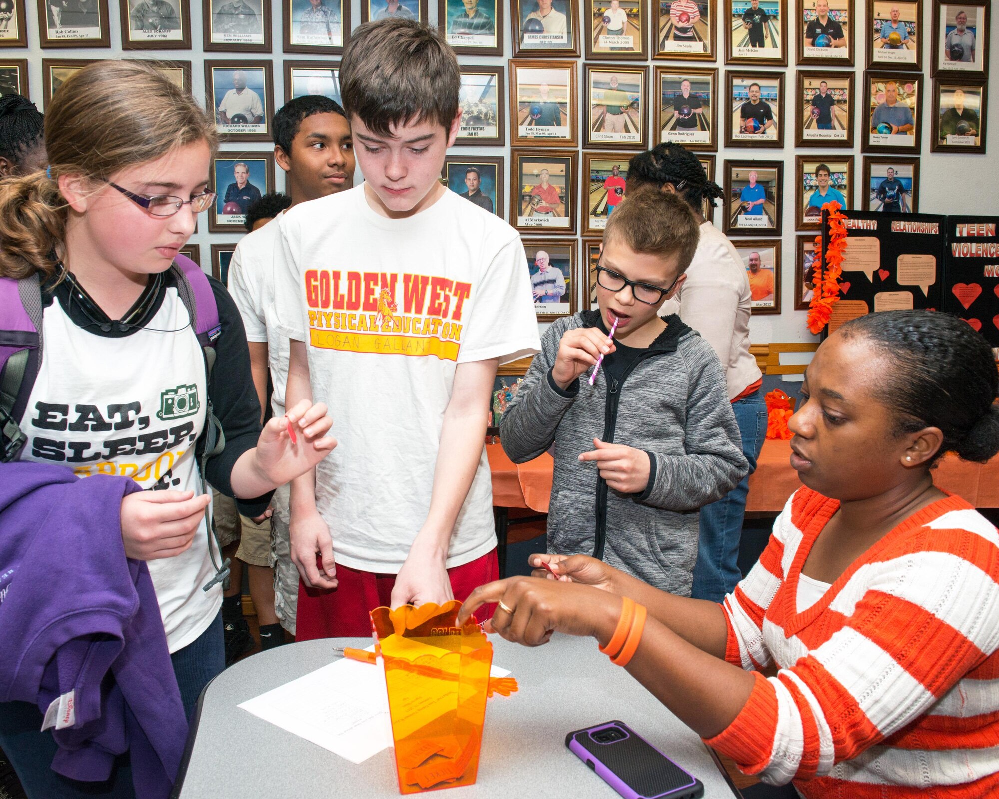 Teenagers from Travis Air Force Base, Calif., check in at the Travis bowling center for an event, Feb. 23, 2017. The event was sponsored by several organizations on base to highlight Teen Dating Violence Awareness Month. (U.S. Air Force photo/Louis Briscese)