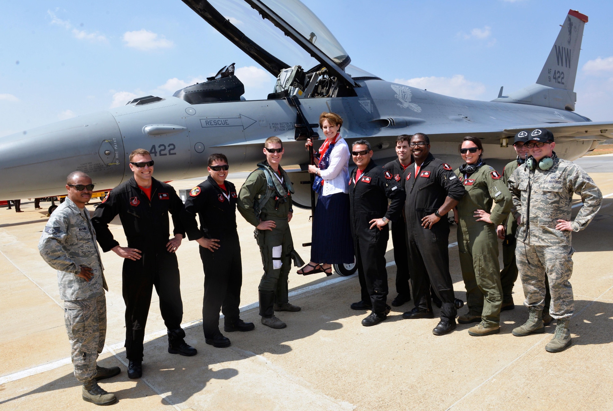 The U.S. Air Force's Pacific Air Forces Demonstration Team members pose for a photo with MaryKay Carlson, Charge d'Affaire for U.S. Mission to India during opening day events for Aero India 2017 at Air Force Station Yelahanka Feb. 16, 2017. The F-16 Fighting Falcon is a compact, multi-role fighter aircraft. It is highly maneuverable and has proven itself in air-to-air combat and air-to-surface attack and provides a relatively low-cost, high-performance weapon system for the United States and allied nations. The United States participates in air shows and other regional events to demonstrate its commitment to the security of the Indo-Asia-Pacific region, promote the standardization and interoperability of equipment, and display capabilities critical to the success of current and future military operations. (U.S. Air Force photo by Capt. Mark Lazane)