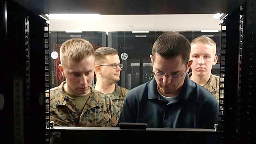 Jason Hessler, an Automated Message Handling System support engineer, trains Marines from Marine Corps Installations West G-6 on the Hyper-Converged Infrastructure system Jan. 11, at Marine Corps Base Camp Pendleton, California. HCI is a virtualization solution that replaces traditional servers, and combines storage and compute functions into a single machine to save cost, energy and space. Marine Corps Systems Command’s Information Systems and Infrastructure recently installed the technology at Camp Lejeune, North Carolina, and Camp Pendleton, California, to support Organizational Messaging Service, which is used to send operational and administrative messages across the Corps. 