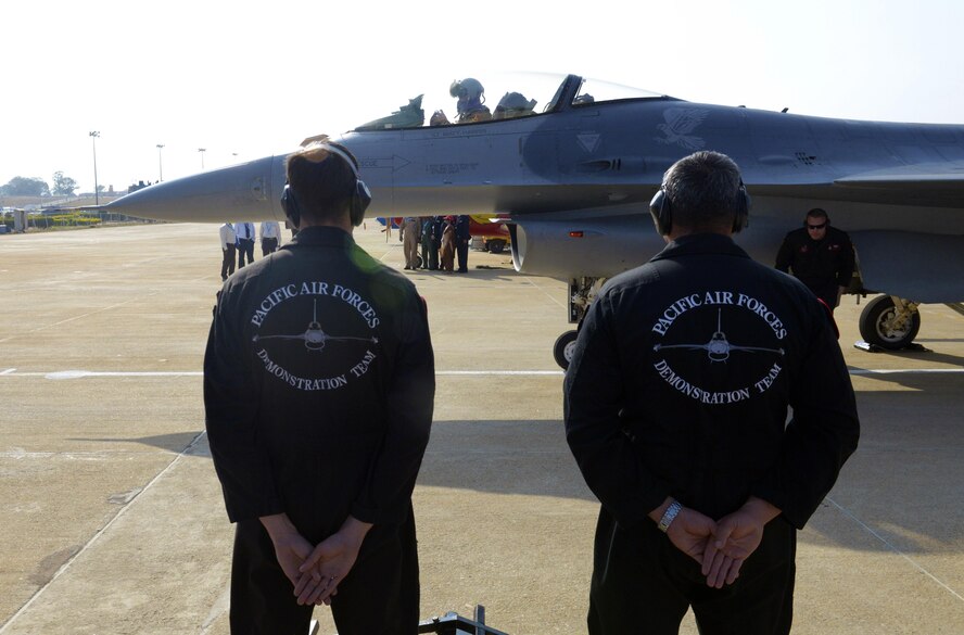 The U.S. Air Force's F-16 Fighting Falcon Pacific Air Forces Demonstration Team maintenance members stand at parade rest while Maj. Richard Smeeding prepares to taxi prior to an aerial performance during Aero India 2017 at Air Force Station Yelahanka Feb. 16, 2017. The F-16 is a compact, multi-role fighter aircraft. It is highly maneuverable and has proven itself in air-to-air combat and air-to-surface attack and provides a relatively low-cost, high-performance weapon system for the United States and allied nations. The United States participates in air shows and other regional events to demonstrate its commitment to the security of the Indo-Asia-Pacific region, promote the standardization and interoperability of equipment and display capabilities critical to the success of current and future military operations. (U.S. Air Force photo by Capt. Mark Lazane)