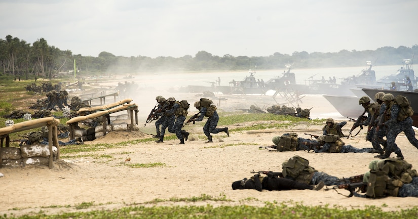 Sri Lankan Marines assault a beach as part of an amphibious capabilities demonstration during the Sri Lanka Marine Corps Boot Camp graduation at Sri Lankan Naval Station Barana in Mullikulum, Sri Lanka, Feb. 27, 2017. The SLMC will be an expeditionary force with specific missions of humanitarian assistance, disaster relief and peacekeeping support.