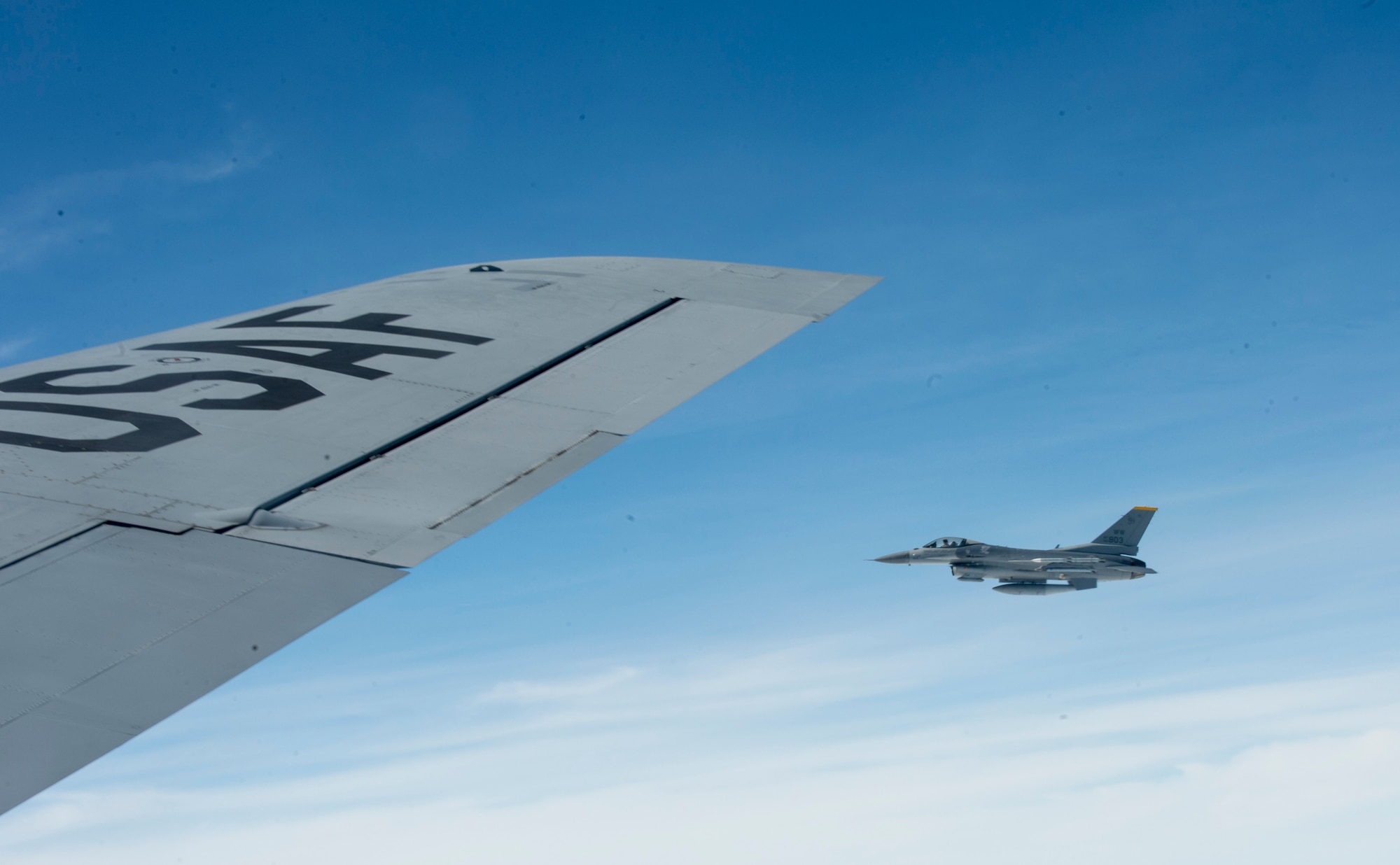 A U.S. Air Force F-16 assigned to the 14th Fighter Squadron from Misawa Air Base, Japan, flies next to a KC-135 Stratotanker after receiving an in-flight fuel during Cope North 2017, Feb. 16, 2017. The exercise includes 22 total flying units and more than 1,700 personnel from three countries and continues the growth of strong, interoperable relationships within the Indo-Asia-Pacific region through integration of airborne and land-based command and control assets. (U.S. Air Force photo by Senior Airman Keith James)