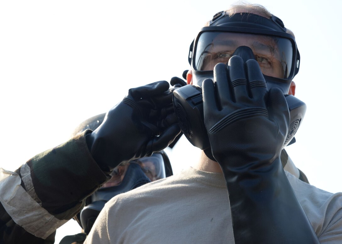 U.S. Air Force Staff Sgt. Nicolette Sanchez, left, with 51st Bioenvironmental, helps Senior Airman Luke Markle, 51st Munitions Armament, with doffing his gas mask during Exercise Beverly Herd 17-1 at Osan Air Base, Republic of Korea, Feb. 28, 2017. The first time being held, civil engineer and medical personnel tested the effectiveness of the chemical contaminant avoidance area, which was designed to quickly process large amounts of individuals through decontamination in a safe zone. (U.S. Air Force photo by Tech. Sgt. Ashley Tyler)
