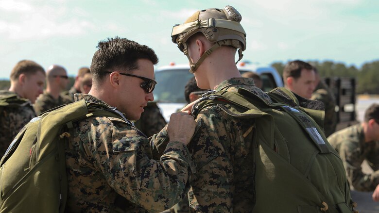 Marines conduct one last check for the integrity of their parachutes before conducting parachute operations at Marine Corps Auxiliary Landing Field Bouge, North Carolina, Feb. 23, 2017. Marines practiced static line and free fall jumps to maintain their certification and keep up to date with their yearly training. The Marines are with 2nd Reconnaissance Battalion. 