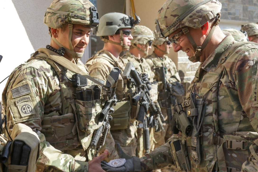 U.S. Army Lt. Gen. Stephen Townsend, commanding general, Combined Joint Task Force-Operation Inherent Resolve and XVIII Airborne Corps, recognizes Cpl. Antonio Batista, an infantryman assigned to 2nd Battalion, 325th Airborne Infantry Regiment, 2nd Brigade Combat Team, 82nd Airborne Division, for his hard work at tactical assembly area Hamam al-Alil, Iraq, Feb. 22, 2017. Paratroopers of the 2nd BCT, 82nd Abn. Div., deployed in support of CJTF-OIR, moved a force into Hamam al-Alil to continue support to the Iraqi federal police during the offensive to liberate West Mosul. The Falcon Brigade enables their Iraqi security forces partners through the advise and assist mission, contributing planning, intelligence collection and analysis, force protection, and precision fires to achieve the military defeat of ISIS. CJTF-OIR is the global Coalition to defeat ISIS in Iraq and Syria. (U.S. Army photo by Staff Sgt. Jason Hull)