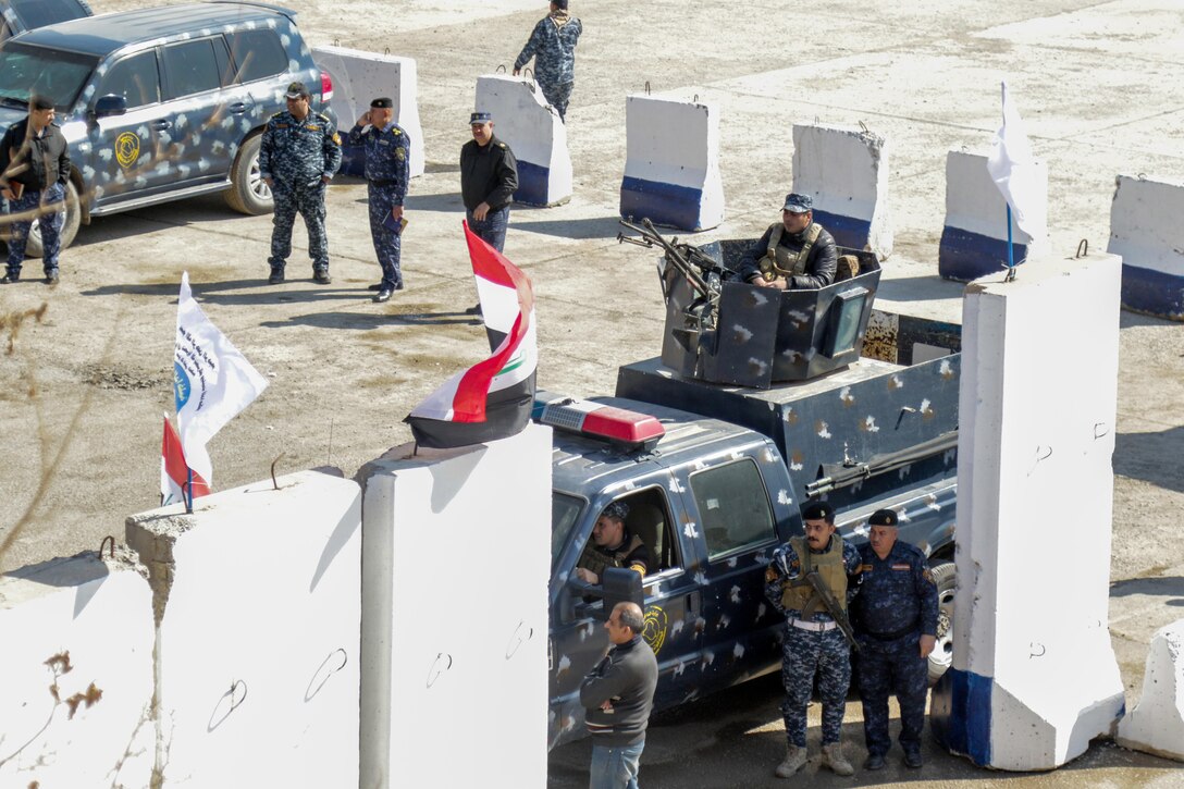 Iraqi federal police marshal at tactical assembly area Hamam al-Alil, Iraq, Feb. 22, 2017.  Paratroopers of the 2nd Brigade Combat Team, 82nd Airborne Division, deployed in support of Combined Joint Task Force-Operation Inherent Resolve, moved a force into Hamam al-Alil to continue support to the Iraqi federal police during the offensive to liberate West Mosul. The Falcon Brigade enables their Iraqi security forces partners through the advise and assist mission, contributing planning, intelligence collection and analysis, force protection, and precision fires to achieve the military defeat of ISIS. CJTF-OIR is the global Coalition to defeat ISIS. (U.S. Army photo by Staff Sgt. Jason Hull)