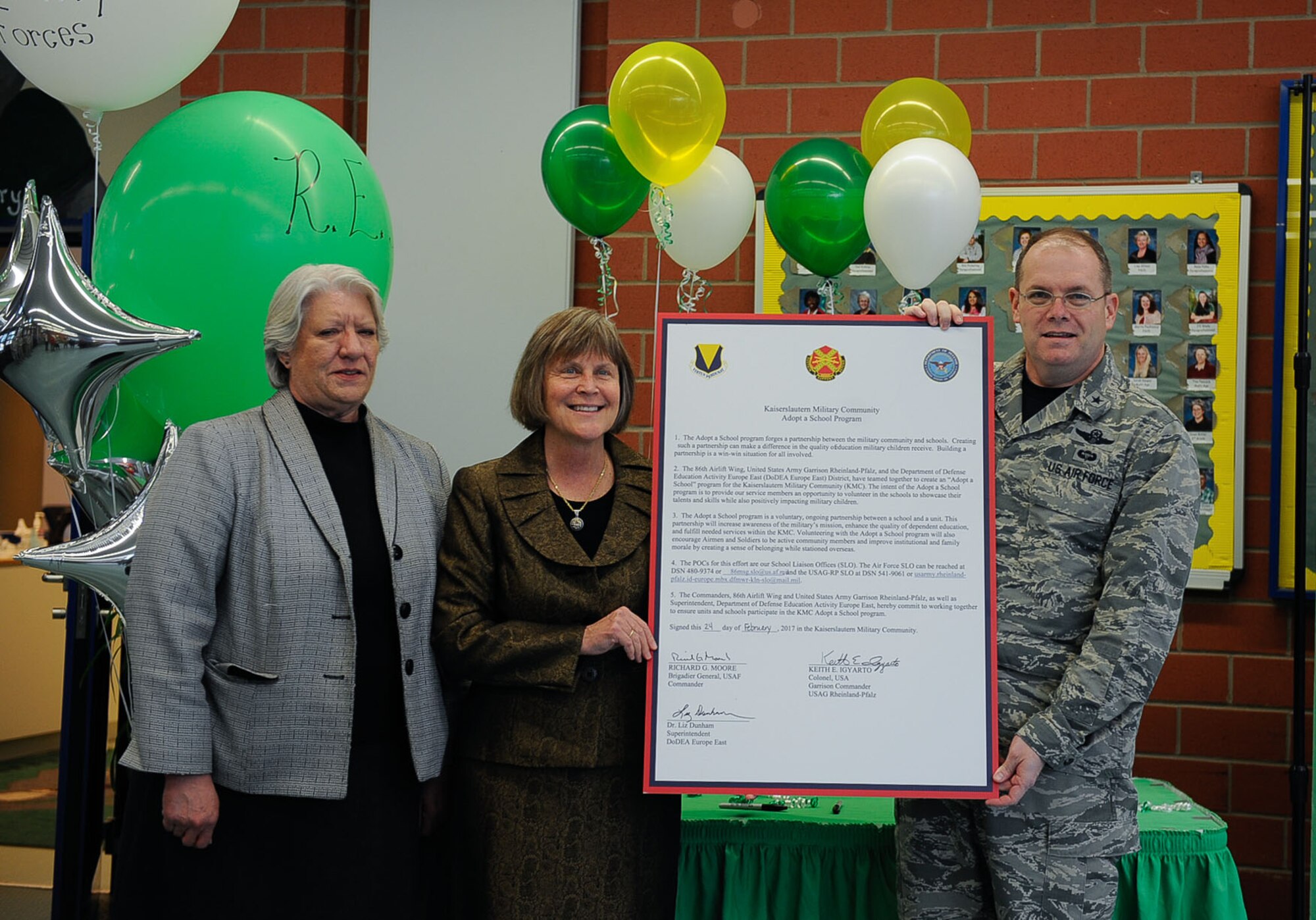 Brig. Gen. Richard Moore, 86th Airlift Wing commander, poses for a photo with school administrators for an Adopt-a-School Program signing at Ramstein Elementary School on Ramstein Air Base, Germany, Feb. 24, 2017. Volunteering with the Adopt-a-School program will encourage Airmen and Soldiers to be active community members and will improve institutional and family morale by creating a sense of belonging while stationed overseas. (U.S. Air Force photo by Airman 1st Class Savannah L. Waters)