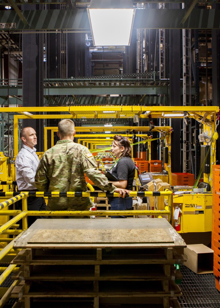 George Atwood, Senior Executive Service, Defense Logistics Agency J3 executive director, discusses the high-rise storage and retrieval system at DLA Distribution Susquehanna, Pennsylvania, with Army Col. Brad Eungard, commander of the distribution center, and Mandy Brechbill, supply management specialist.