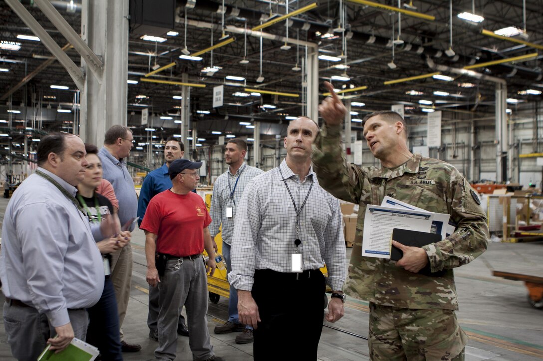 Army Col. Brad Eungard, Defense Logistics Agency Distribution Susquehanna, Pennsylvania, commander, shows George Atwood, Senior Executive Service, DLA J3 executive director, the dedicated truck lanes at the distribution center.