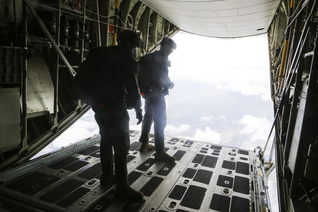 Jumpmasters survey the ground to ensure a safe landing at Marine Corps Auxiliary Landing Field Bouge, N.C., Feb. 23, 2017. Marines participated in static line and free fall jumping from the back of a Lockheed C-130 Hercules to prepare them for possible future combat parachute operations. The Marines are with 2nd Reconnaissance Battalion. (U.S. Marine Corps photo by Lance Cpl. Miranda Faughn)