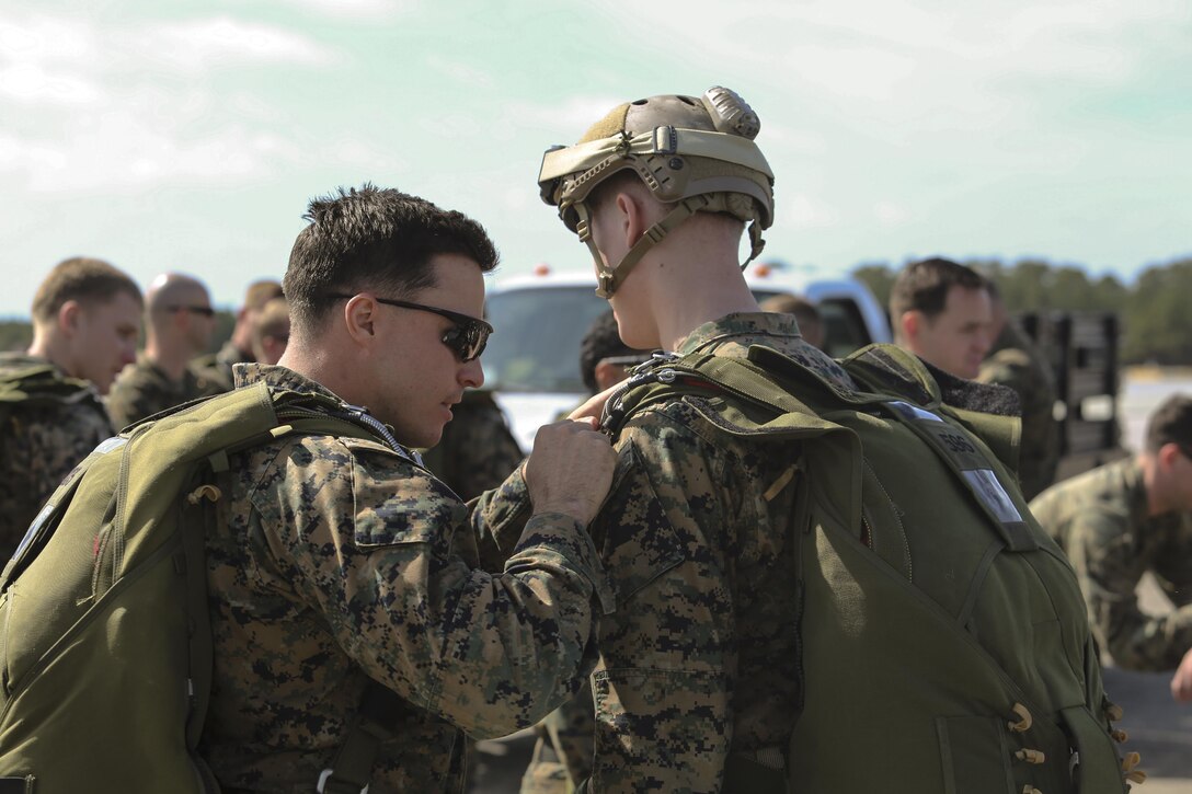Marines conduct one last check for the integrity of their parachutes before conducting parachute operations at Marine Corps Auxiliary Landing Field Bouge, N.C., Feb. 23, 2017. Marines practiced static line and free fall jumps to maintain their certification and keep up to date with their yearly training. The Marines are with 2nd Reconnaissance Battalion. (U.S. Marine Corps photo by Lance Cpl. Miranda Faughn)