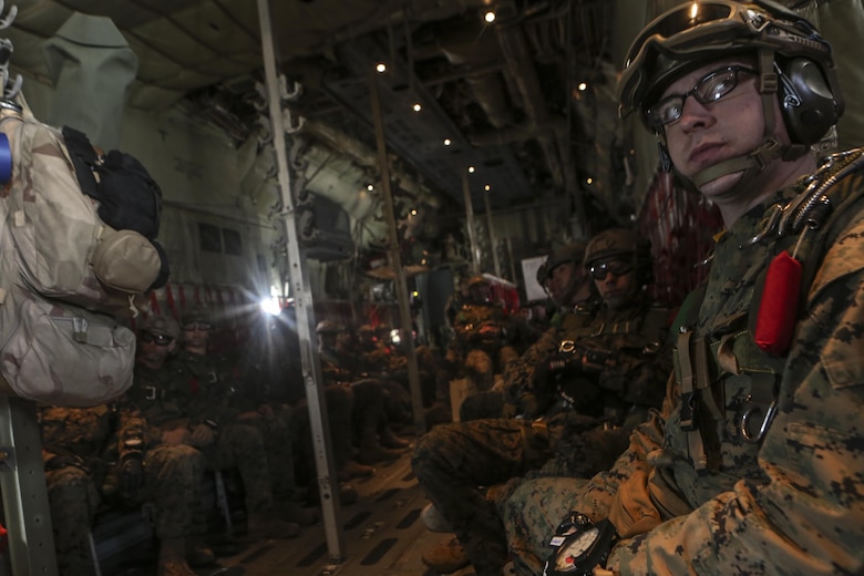 Marines wait for the signal to dive from the back of an aircraft to land at Marine Corps Auxiliary Landing Field Bouge, N.C., Feb. 23, 2017. Marines practiced static line and free fall jumps to maintain their certification and train for parachute operations. The Marines are with 2nd Reconnaissance Battalion. (U.S. Marine Corps photo by Lance Cpl. Miranda Faughn)