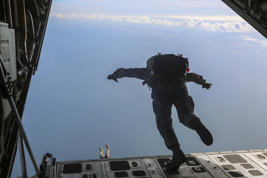 A Marine dives from the back of a Lockheed C-130 Hercules to land at a pre-determined landing zone at Marine Corps Auxiliary Landing Field Bouge, N.C., Feb. 23, 2017. The Marine conducted high-altitude free fall jumps as part of their yearly training for combat parachute operations. The Marine is with 2nd Reconnaissance Battalion. (U.S. Marine Corps photo by Lance Cpl. Miranda Faughn)