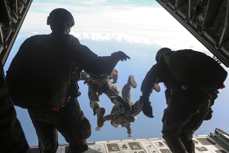 Marines dive from the back of a Lockheed C-130 Hercules at Marine Corps Auxiliary Landing Field Bouge, N.C., Feb. 23, 2017. These Marines conducted high-altitude free fall jumps as part of their yearly training for combat parachute operations. The Marines are with 2nd Reconnaissance Battalion. (U.S. Marine Corps photo by Lance Cpl. Miranda Faughn)