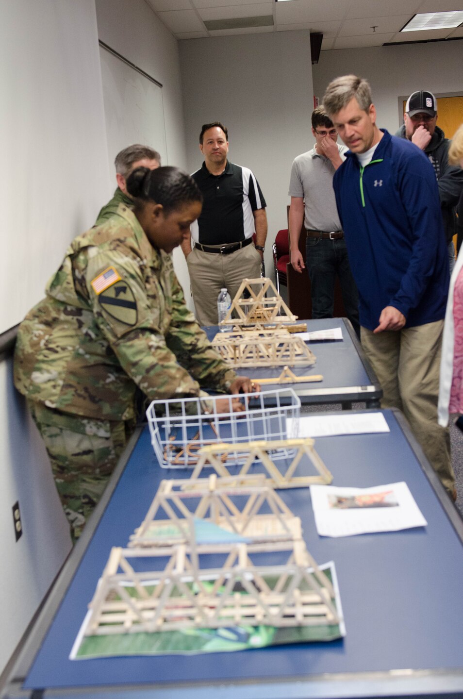 TAM Deputy Commander LTC Taneha Carter and DPPM Tom Waters look over the submissions for the competition before the judging starts, marking National Engineers Week, Feb. 24. 
