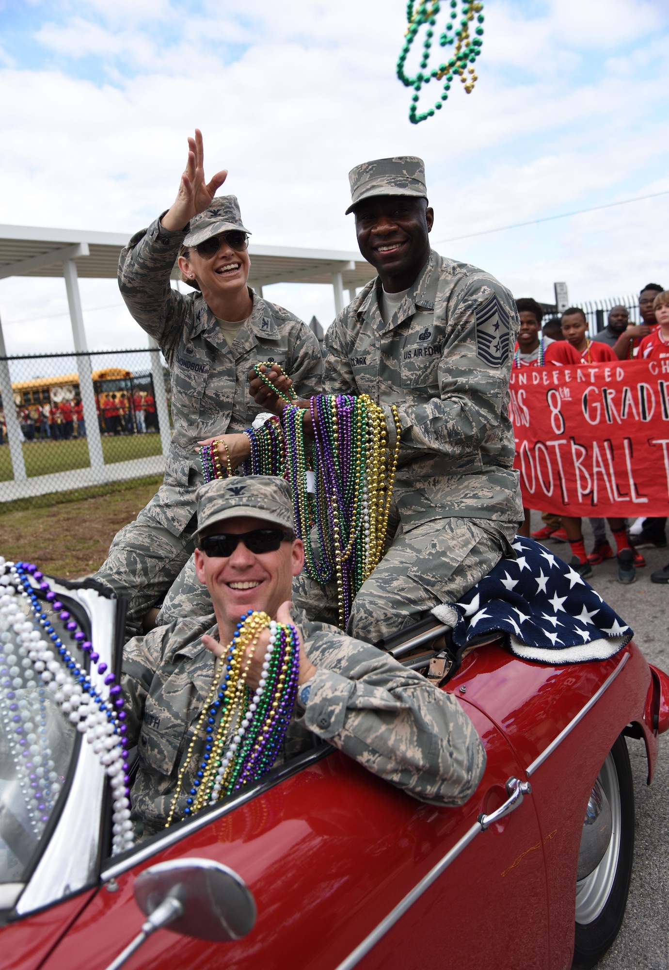 Col. C. Mike Smith, 81st Training Wing vice commander, drives Col. Michele Edmondson, 81st TRW commander, and Chief Master Sgt. Vegas Clark, 81st TRW command chief, as they serve as Grand Marshals during the Jeff Davis Elementary School Mardi Gras Parade, Feb. 24, 2017, Biloxi, Miss. The Keesler AFB Honor Guard and other base personnel also participated in the festivities. (U.S. Air Force photo by Kemberly Groue)