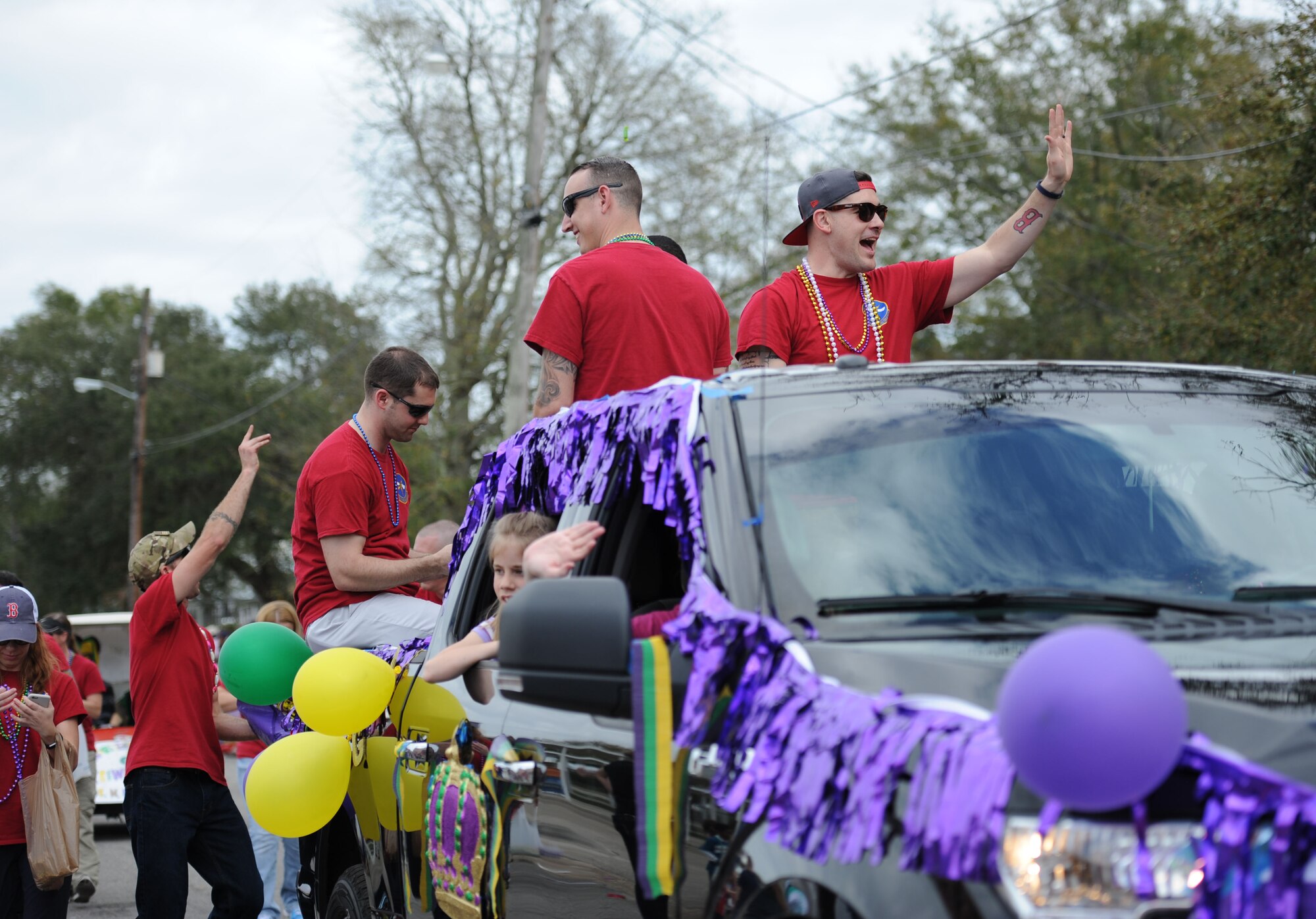 Members from the 335th Training Squadron participate in the Jeff Davis Elementary School Mardi Gras Parade, Feb. 24, 2017, Biloxi, Miss. The Keesler AFB Honor Guard and other base personnel also participated in the festivities. (U.S. Air Force photo by Kemberly Groue)