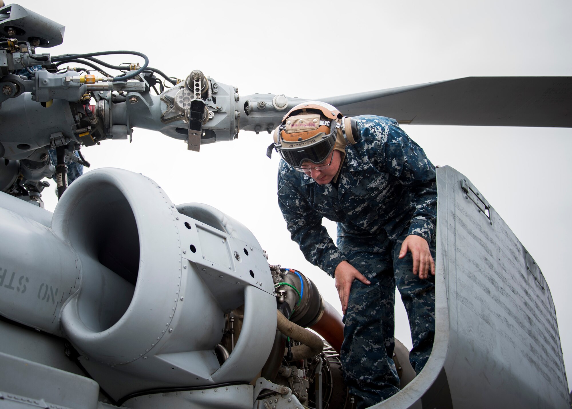 Petty Officer 1st Class Cameron Small, Helicopter Maritime Strike Squadron 72 from Jacksonville, Fla., conducts turn-around maintenance on an MH-60R helicopter Feb. 7 during Combat Hammer.   The 86th Fighter Weapons Squadron’s Combat Hammer is a weapons system evaluation program at Eglin Air Force Base, Fla. (U.S. Air Force photo/Ilka Cole)