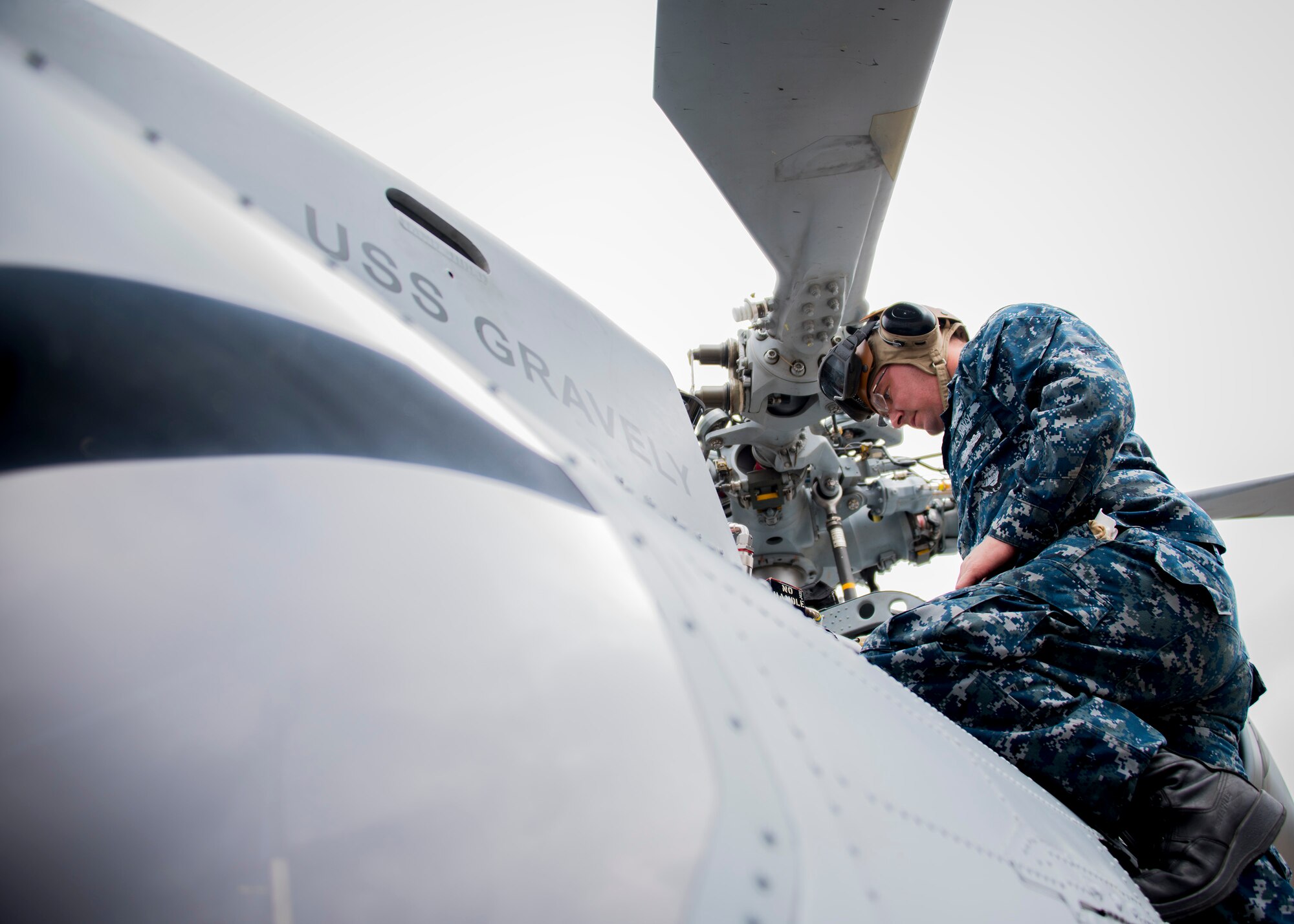 Petty Officer 1st Class Cameron Small, Helicopter Maritime Strike Squadron 72 from Jacksonville, Fla., conducts turn-around maintenance on an MH-60R helicopter Feb. 7 during Combat Hammer.   The 86th Fighter Weapons Squadron’s Combat Hammer is a weapons system evaluation program at Eglin Air Force Base, Fla. (U.S. Air Force photo/Ilka Cole)