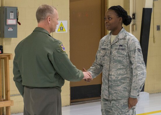 Lt. Gen Mark Kelly, 12th Air Force (Air Forces Southern) Commander, coins outstanding performer SrA Undrea Richardson, 366th Equipment Maintenance Squadron member, Feb. 23, 2017, at Mountain Home Air Force Base, Idaho. Four outstanding performers from different squadrons received coins from Kelly during his visit. (U.S. Air Force photo by Airman Jeremy D. Wolff/Released)