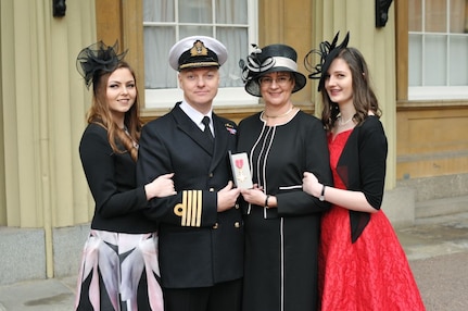 Royal Navy Capt. Dicky Daws (second from left), U.S. Strategic Command’s (USSTRATCOM) United Kingdom Liaison Officer, his wife Petrina (second from right) and their daughters Victoria (left) and Alexandra (right), at Buckingham Palace, London, U.K., after Capt. Daws was appointed to the Order of the British Empire (OBE) in the 2016 Queen’s 90th Birthday Honors List. His Royal Highness, Charles Philip Arthur George, Prince of Wales (not pictured), presented the award to Daws at an investiture ceremony at Buckingham Palace on Feb. 10, 2017, for helping to deepen and enhance the operational planning relationship between the U.K. Ministry of Defence and USSTRATCOM while serving as the U.K. Liaison Officer at USSTRATCOM headquarters in Omaha, Neb. The OBE was established on June 4, 1917, by King George V and is made for public service and contributions to the arts and sciences and work with charitable and welfare organizations.  One of nine DoD unified combatant commands, USSTRATCOM has global strategic missions assigned through the Unified Command Plan that include strategic deterrence; space operations; cyberspace operations; joint electronic warfare; global strike; missile defense; intelligence, surveillance and reconnaissance; and analysis and targeting.