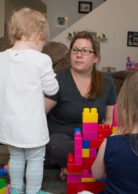 Sarah Morin, a Family Child Care provider, assist children during play time in her home at Hanscom Air Force Base, Mass., last year. The 66th Force Support Squadron has named Morin the Hanscom Family Child Care Provider of the Year for 2016. (U.S. Air Force photo by Jerry Saslav) 