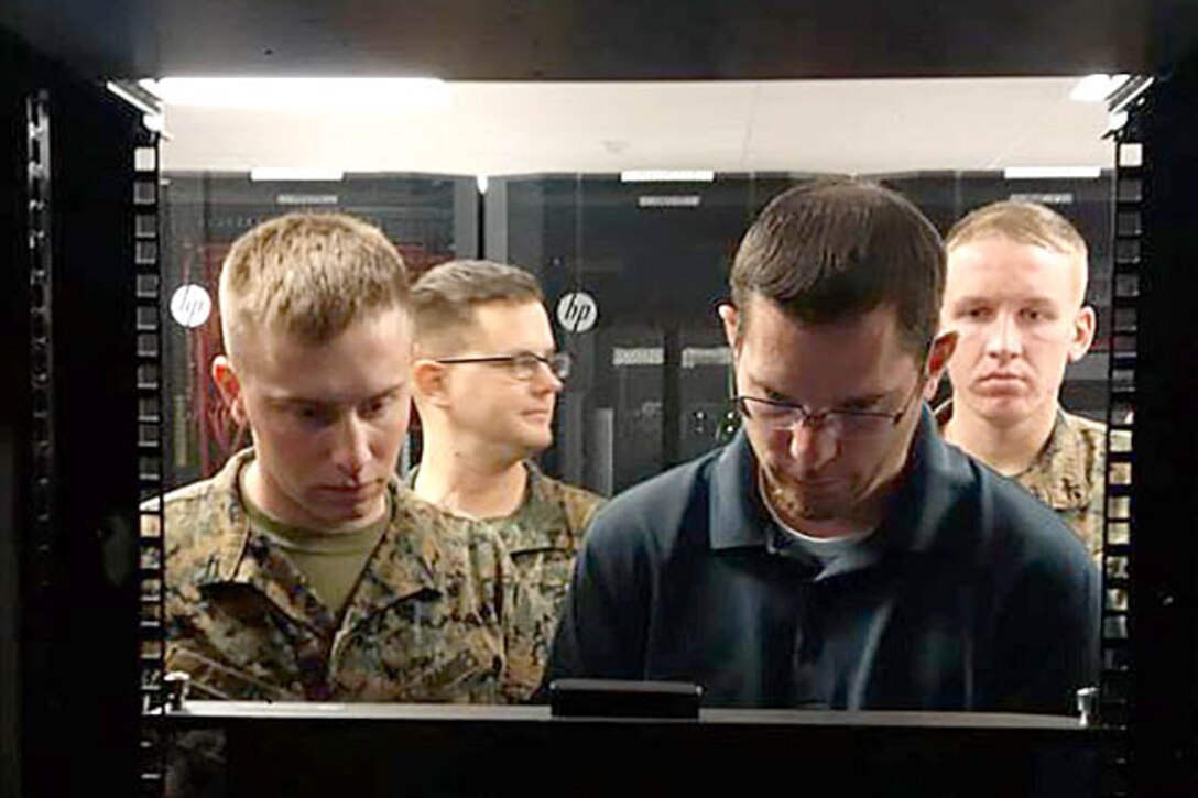 Jason Hessler, an Automated Message Handling System support engineer, trains Marines from Marine Corps Installations West G-6 on the Hyper-Converged Infrastructure system at Marine Corps Base Camp Pendleton, Calif., Feb. 15, 2017. HCI is a virtualization solution that replaces traditional servers and combines storage and compute functions into a single machine to save money, energy and space. Marine Corps photo