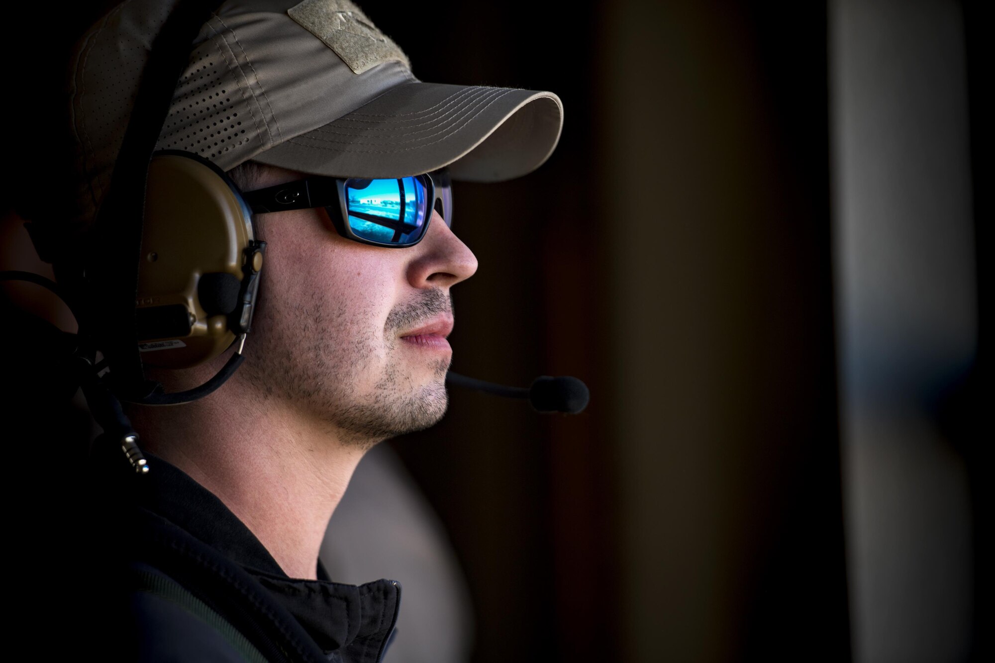 Senior Airman Shane Hardin, 563d Operations Support Squadron, scans through a window while acting as an oppositional force member, Feb. 22, 2017, at the Playas Training and Research Center, N.M. OPFOR is a role designed to simulate downrange threats and complicate training objectives with the ultimate goal of creating a realistic training environment for units preparing to deploy. Airmen from the 563d OSS fill this role in support of numerous joint exercises each year utilizing aircraft-threat emitters, vehicle-mounted simulation weapons and waves of ground troops. (U.S. Air Force photo by Staff Sgt. Ryan Callaghan)