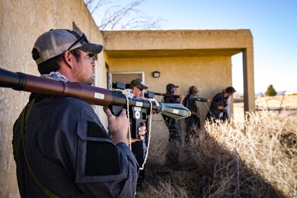 Tech. Sgt. Mykal Sequeria, left, and Airmen from the 563d Operations Support Squadron simulate oppositional forces, Feb. 22, 2017, at the Playas Training and Research Center, N.M. OPFOR is a role designed to simulate downrange threats and complicate training objectives with the ultimate goal of creating a realistic training environment for units preparing to deploy. Airmen from the 563d OSS fill this role in support of numerous joint exercises each year utilizing aircraft-threat emittors, vehicle-mounted simulation weapons and waves of ground troops. (U.S. Air Force photo by Staff Sgt. Ryan Callaghan)