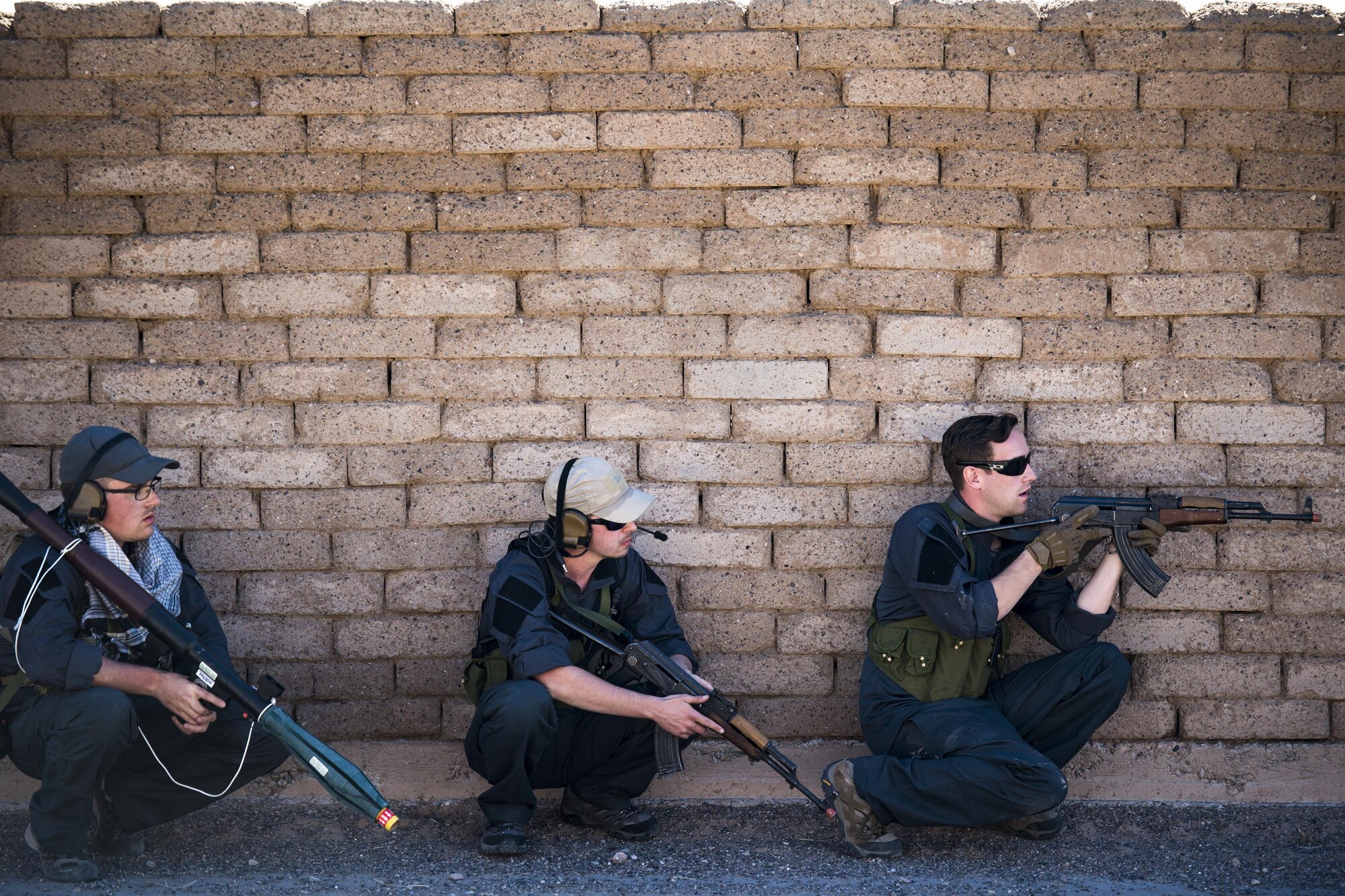 Staff Sgt. Nathan Franey, left, Senior Airman Shane Hardin, center, and Staff Sgt. Eric Fullmer, 563d Operations Support squadron, act as oppositional forces, Feb. 22, 2017, at the Playas Training and Research Center, N.M. OPFOR is a role designed to simulate downrange threats and complicate training objectives with the ultimate goal of creating a realistic training environment for units preparing to deploy. Airmen from the 563d OSS fill this role in support of numerous joint exercises each year utilizing aircraft-threat emittors, vehicle-mounted simulation weapons and waves of ground troops. (U.S. Air Force photo by Staff Sgt. Ryan Callaghan)