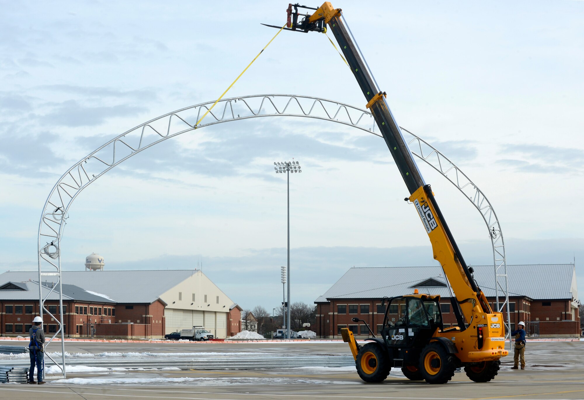 Members of the Big Top Manufacturing Company move a support beam for a sun shade at Joint Base Langley-Eustis, Va., Jan. 12, 2017. The company was contracted through the 633rd Contracting Squadron to ensure the 1st Fighter Wing’s F-22 Raptors are protected from the sun and other natural elements. (U.S. Air Force photo by Airman 1st Class Kaylee Dubois)