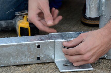 Tyler Padgett, Big Top Manufacturing Company technician, secures a support beam for a sun shade at Joint Base Langley-Eustis, Va., Jan. 12, 2017. The sun shades will provide protection to the 1st Fighter Wing aircraft mechanics from the weather while they maintain the aircraft.  (U.S. Air Force photo by Airman 1st Class Kaylee Dubois)