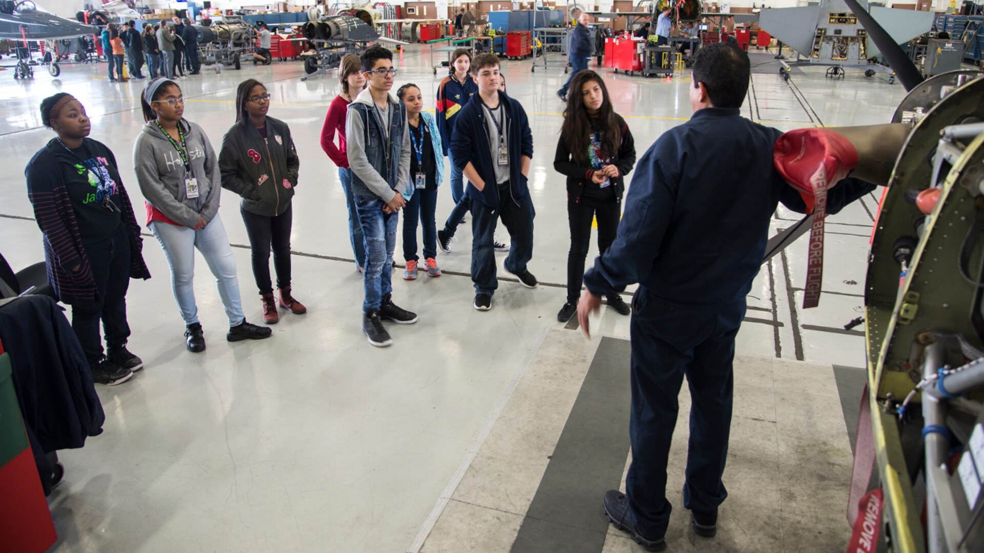 An aircraft maintainer from the 12th Maintenance Group shows students from the Judson High School Science, Technology, Engineering, and Mathematics Academy ongoing repairs to a T-6 Texan II Feb. 2, 2017 at Joint Base San Antonio-Randolph. The students participated in the 2017 Job Shadow Day. 