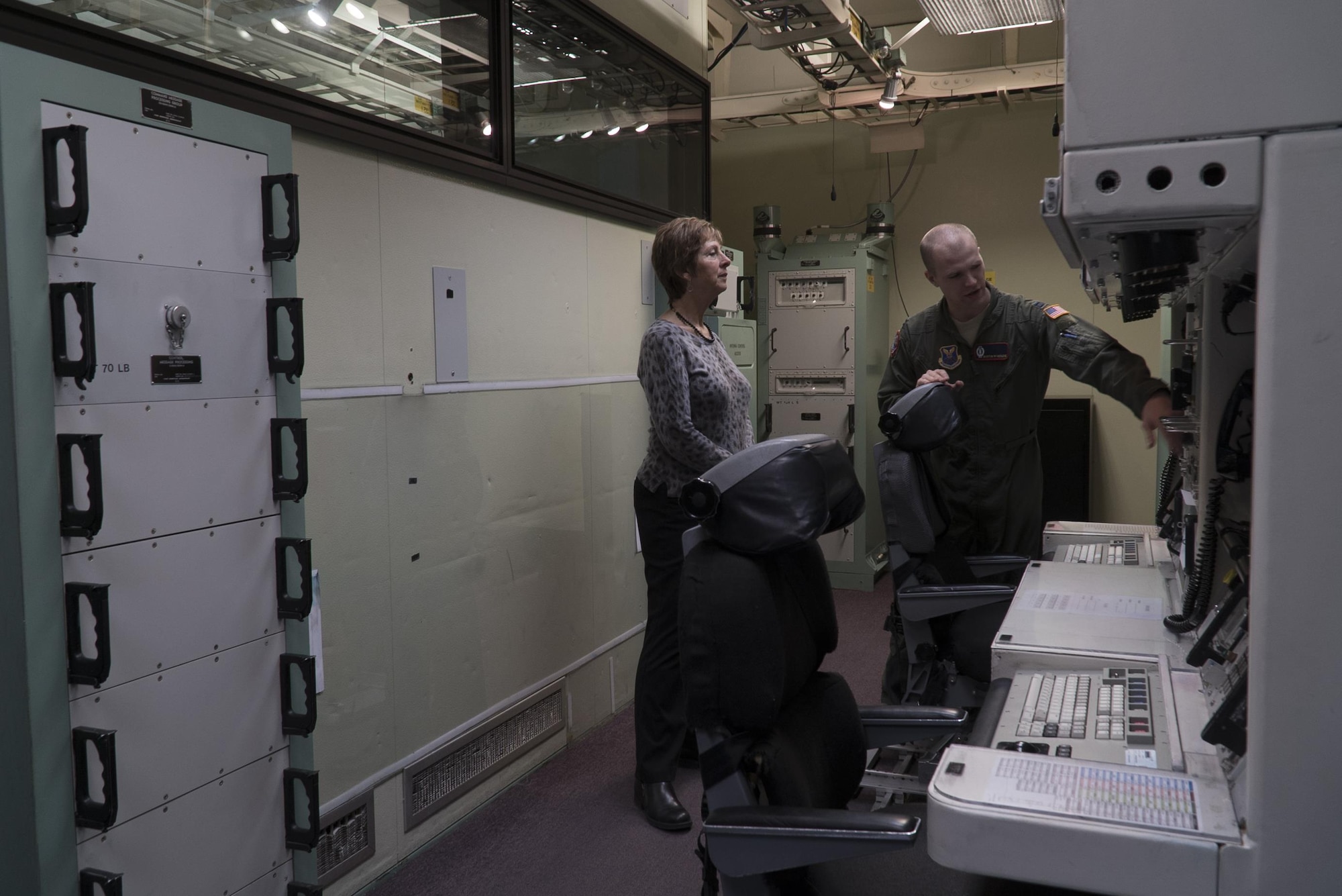 Laura Hyten, wife of Gen. John E. Hyten, U.S. Strategic Command commander, listens as Capt. Austin McKenzie, 90th Operations Group chief missile procedural trainer officer, discusses life as a missileer during a site visit to the 90th Operations Support Squadron’s missile procedure trainer on F.E. Warren Air Force Base, Wyo., Feb. 22, 2017. The MPT allows missileers to run through a number of potential situations that can arise when on alert. Mrs. Hyten toured the base to meet with Airmen and families of the Mighty Ninety. (U.S. Air Force Photo by Lan Kim)