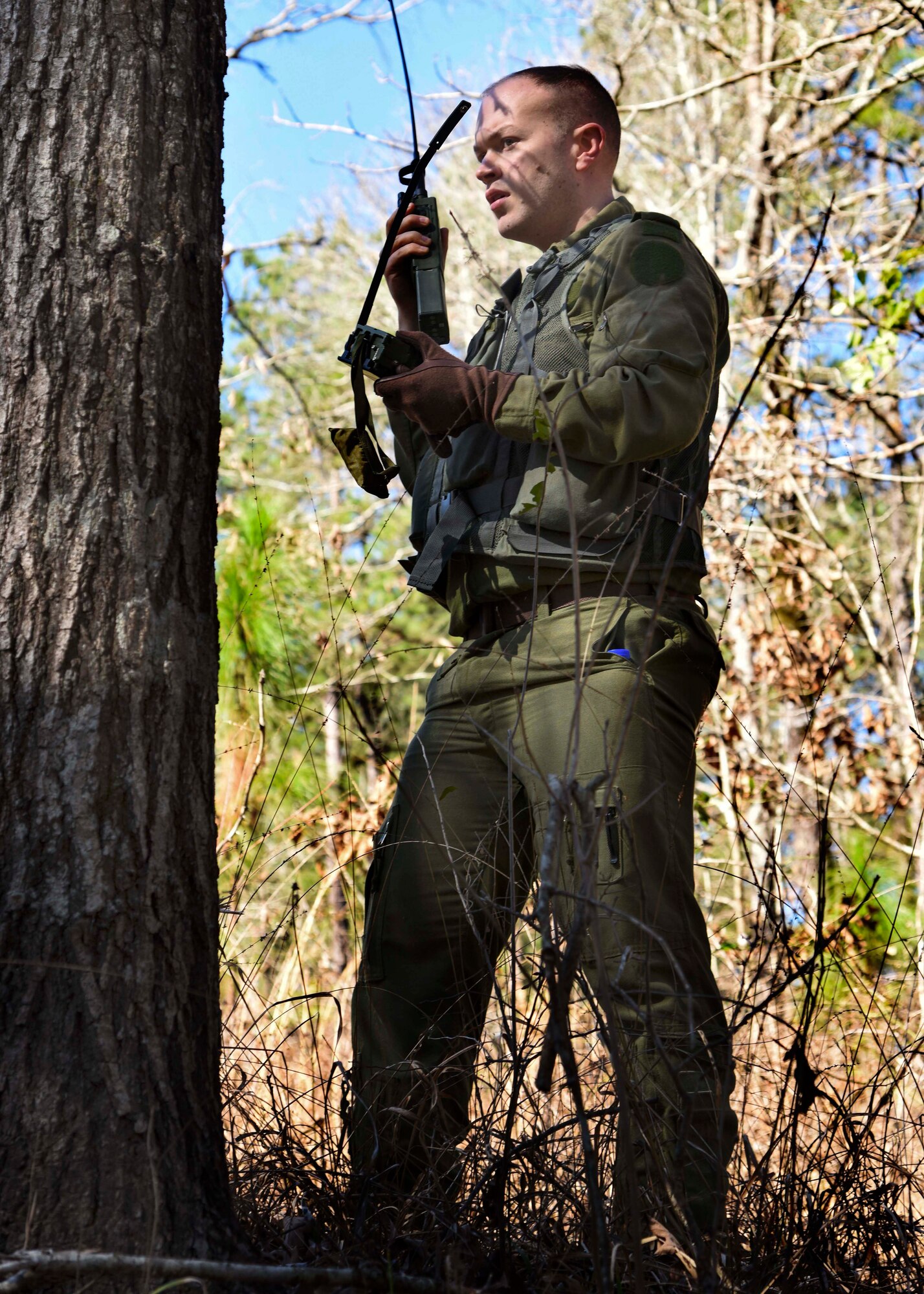 Royal Canadian Air Force Cpl. Teddy Lapkin, 436 Transport Squadron technical crewman, attempts to contact a C-130J during survival, evasion, resistance and escape training Feb. 10, 2017, near Alexandria, La. SERE training is conducted to aid aircrew in survival techniques such as building shelter, land navigation and procuring water to evade the enemy until they can be rescued. (U.S. Air Force photo by Senior Airman Stephanie Serrano)