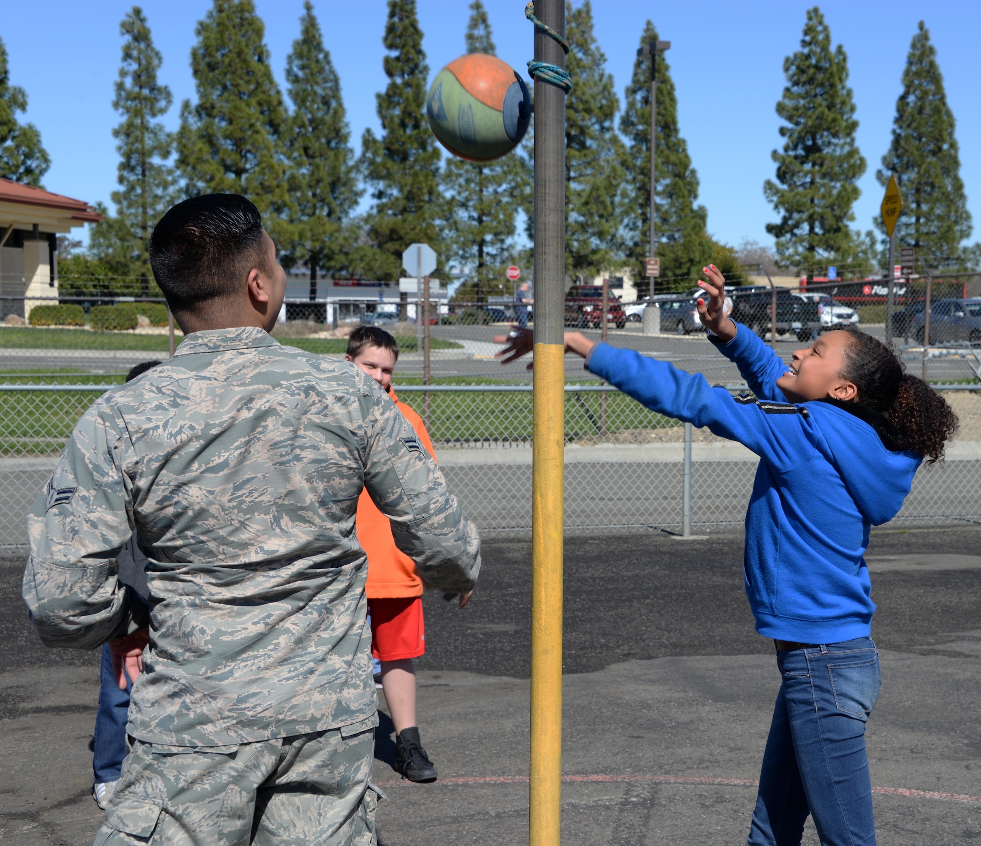 Airman 1st Class Frederick Cabling, 60th Aerial Port Squadron traffic management office, watches as a child plays outside Travis Elementary School at Travis Air Force Base, Calif., Feb. 27, 2017. Cabling is one of nearly 70 Airmen who have volunteered at the school since Jan. 30. (U.S. Air Force photo/Tech. Sgt. James Hodgman/Released)