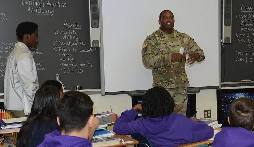 U.S. Army Staff Sgt. William Thomas, 221st Military Police Detachment training NCO, speaks to students about his job during a career fair at Crittenden Middle School in Newport News, Va., Feb. 22, 2017. U.S. Army Soldiers and U.S. Air Force Airmen from Joint Base Langley-Eustis, Va., participated in the event to give students an understanding of careers available within the Armed Forces. (U.S. Air Force photo by Staff Sgt. Teresa J. Cleveland)