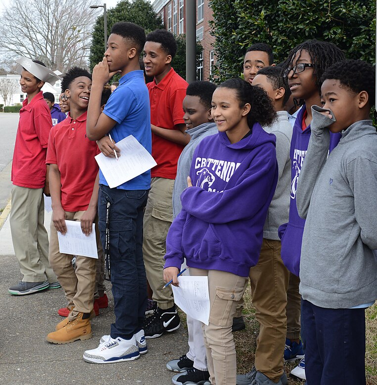 Students watch as members of the 221st and 3rd Military Police Detachments from Joint Base Langley-Eustis, Va., demonstrate the capabilities and training requirements needed to work with a military working dog during a career fair at Crittenden Middle School in Newport News, Va., Feb. 22, 2017. Law enforcement personnel from JBLE participated in the event to strengthen relationships within the community and provide information to students regarding military careers and educational benefits. (U.S. Air Force photo by Staff Sgt. Teresa J. Cleveland)