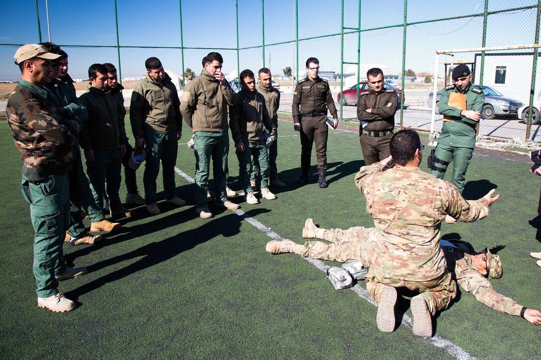 Army Sgt. Jeremy Martinez, right, illustrates tactical combat casualty care to Kurdish security forces near Erbil, Iraq, Feb. 19, 2017. Martinez is a medic assigned to the 82nd Airborne Division’s Company B, 2nd Battalion, 325th Airborne Infantry Regiment, 2nd Brigade Combat Team. Army photo by Spc. Craig Jensen