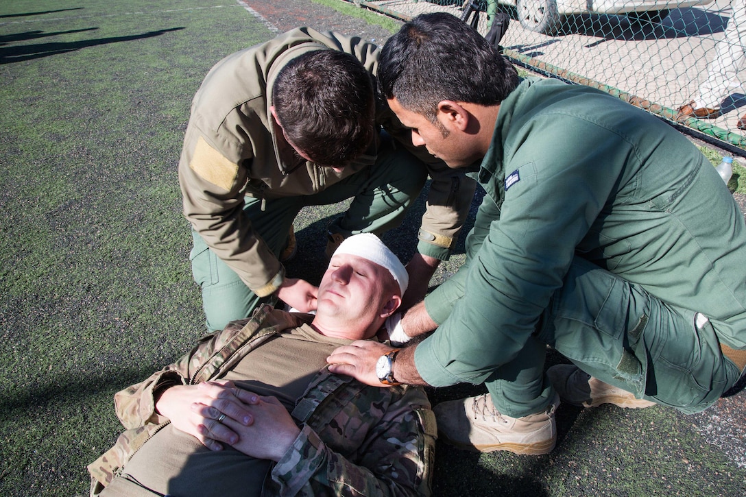 Kurdish security forces members apply combat gauze to the head of Army Sgt. Andrew Britt during a tactical combat casualty care class near Erbil, Iraq, Feb. 19, 2017. Britt is assigned to the 82nd Airborne Division’s Company B, 2nd Battalion, 325th Airborne Infantry Regiment, 2nd Brigade Combat Team. Army photo by Spc. Craig Jensen