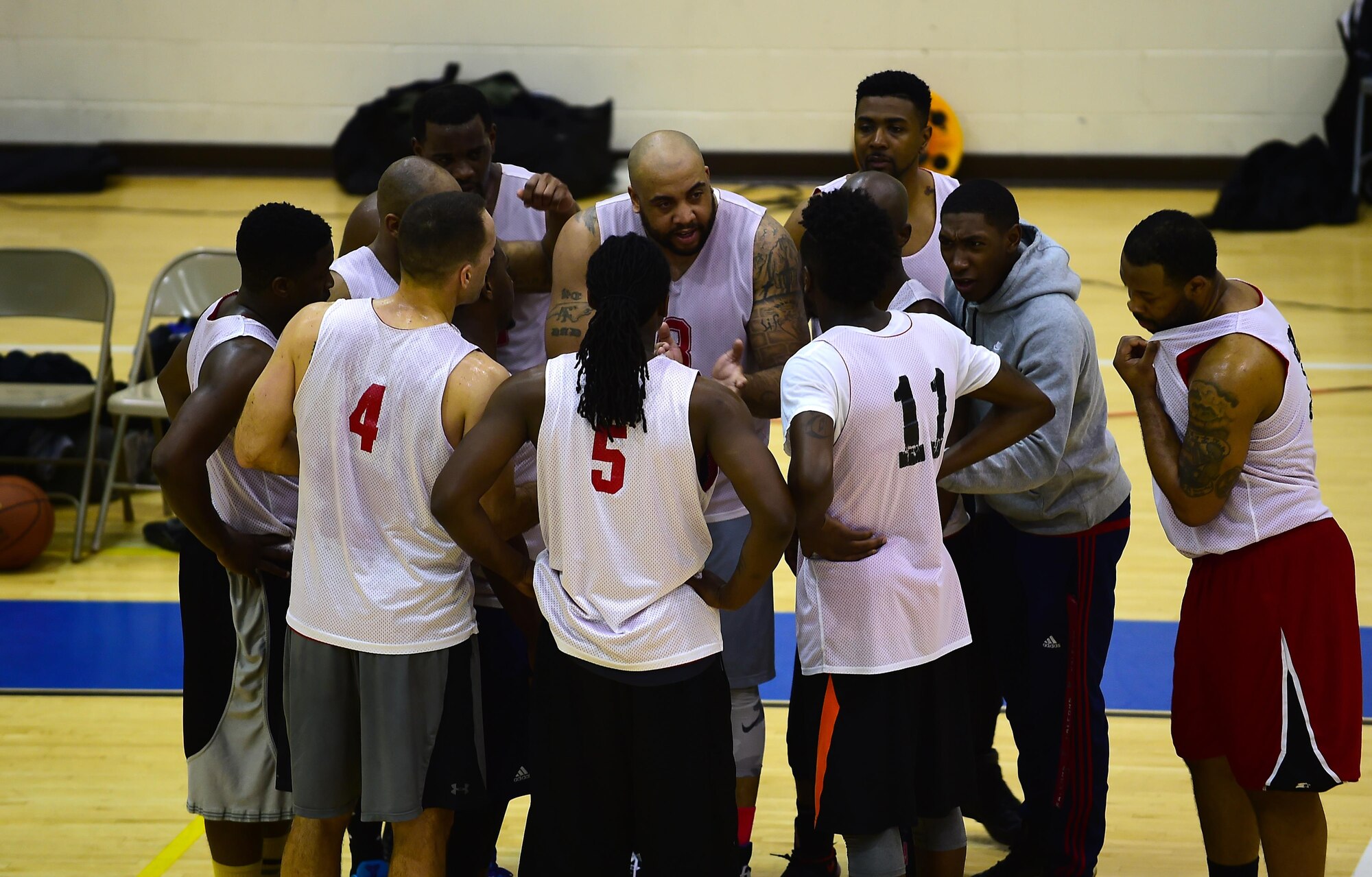 Members of the Ryan Center 2016-2017 intramural basketball team, huddle before returning to the championship game at Joint Base Langley-Eustis, Va., Feb. 22, 2017. During the game, team members of the Ryan Center team motivated and cheered each other on, ultimately winning the game. (U.S. Air Force photo by Senior Airman Kimberly Nagle)