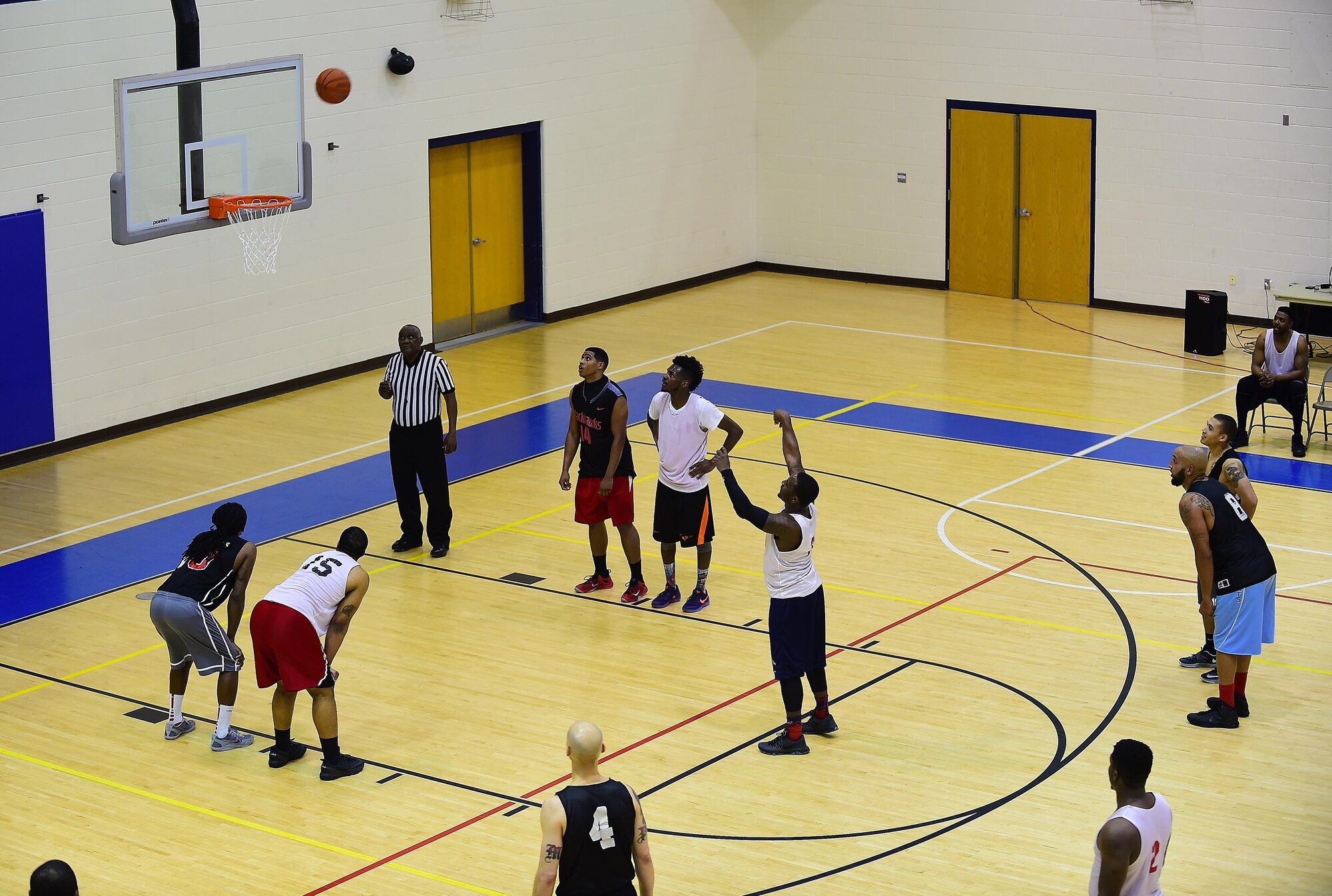 A member of the Ryan Center intramural basketball team shoots a free throw during the 2016-2017 intramural basketball championship game at Joint Base Langley-Eustis, Va., Feb. 22, 2017. Calls during the game were made by one of the three referees ensuring the safety and fairness of the two 20-minute halves. (U.S. Air Force photo by Senior Airman Kimberly Nagle)    